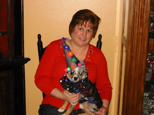 A woman with a small dog on her lap